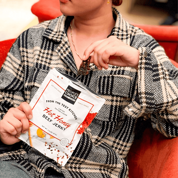 Person holding a bag of Hot Honey Beef Jerky